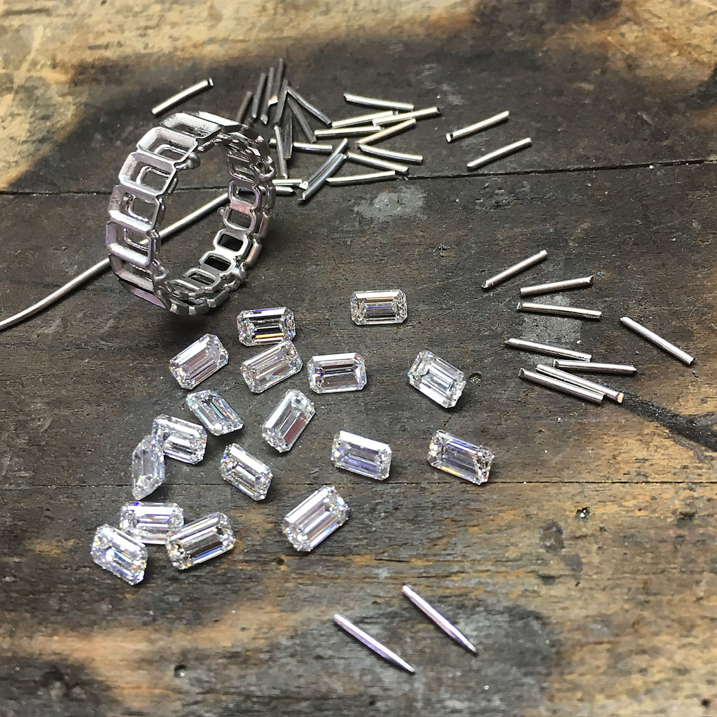 Handmade eternity band in platinum with emerald cut diamonds