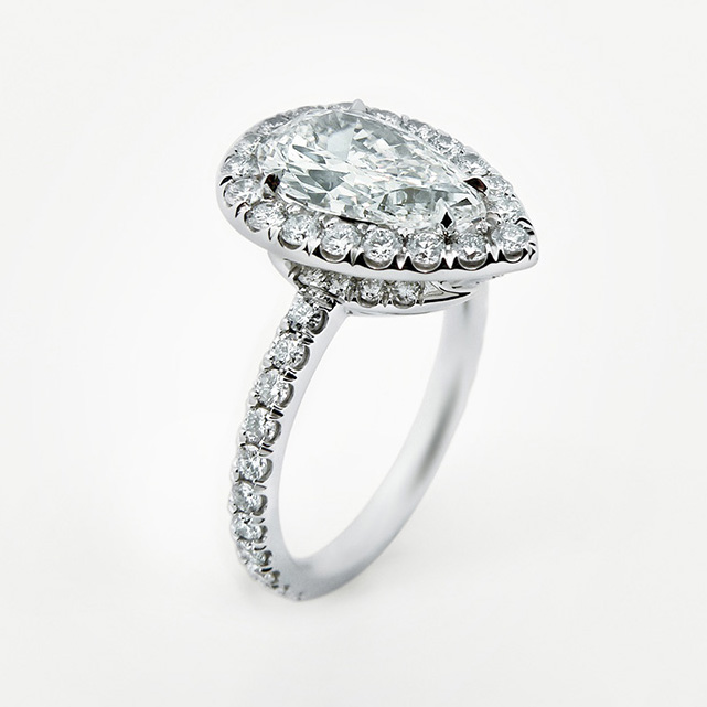 Pavé-set ring with pear shape diamond
